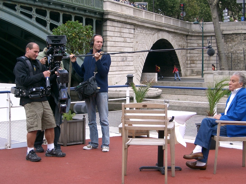 Film crew with sound man holding boom mic