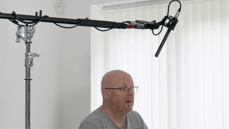 A shotgun mic shown in a good position for recording the sound of the Tallent's voice