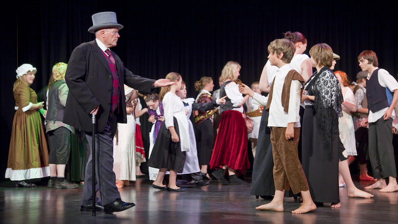 A scene from a school musical production of Oliver.