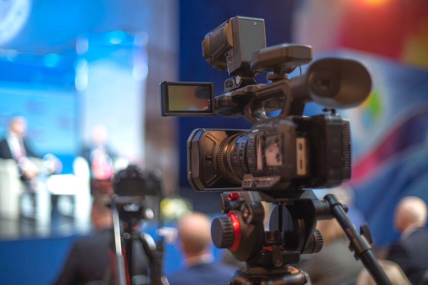 A camera being used to film an event.